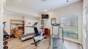 Rancho Cucamonga apartment for rent - A home gym with a treadmill, exercise bike, and other equipment.