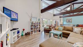 Rancho Cucamonga apartment for rent - A living room with a television, bookshelves, and a couch.