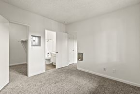 Montclair apartment for rent - A white bedroom with a carpeted floor and a white door.