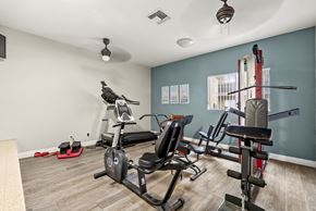 Montclair apartment for rent - A home gym with a variety of equipment including a treadmill, stationary bike, and weight rack.