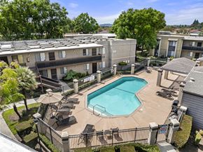 Montclair apartment for rent - A swimming pool surrounded by a black fence and chairs.