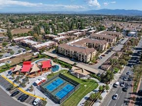 Chino apartment for rent - A large building complex with a pool in the foreground.