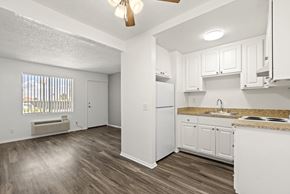 Rancho Cucamonga apartment for rent - A kitchen with white cabinets and a white refrigerator.