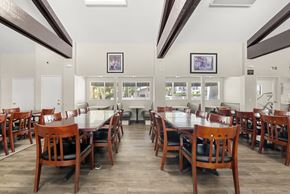 Rancho Cucamonga apartment for rent - A dining room with a long table and chairs.