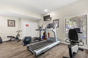 Rancho Cucamonga apartment for rent - A home gym with a treadmill, exercise bike, and other equipment.