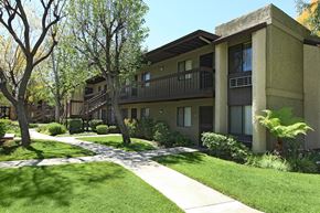 Montclair apartment for rent - A building with a balcony and a tree in front of it.