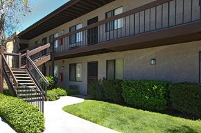 Montclair apartment for rent - A building with a balcony and stairs leading to it.