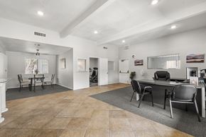 Palm Springs apartment for rent - A spacious room with a dining table and chairs.