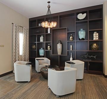 Chino apartment for rent - A living room with a brown carpet and a white chair.
