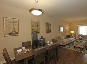 Chino apartment for rent - A dining room with a table set for two and a couch in the background.