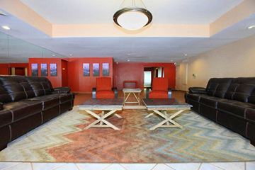 Los Angeles apartment for rent - a living room with leather couches and a table and chairs