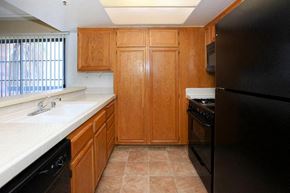 Los Angeles apartment for rent - a kitchen with black appliances and white counter tops