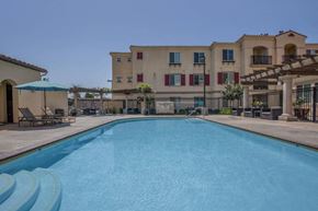 Chino apartment for rent - a large swimming pool with a building in the background