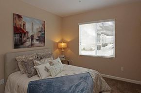 Chino apartment for rent - a bedroom with a bed and a painting on the wall