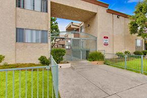 North Hills apartment for rent - A building with a gate and a sign on it.