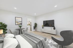 Mission Hills apartment for rent - A modern bedroom with a large bed and a television.