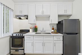 Mission Hills apartment for rent - A kitchen with white cabinets and a black refrigerator.