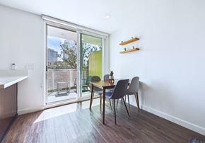 Los Angeles apartment for rent - A dining room with a table and chairs and a sliding glass door.