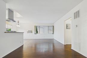 Beverly Hills apartment for rent - A spacious, empty room with wooden floors and white walls.