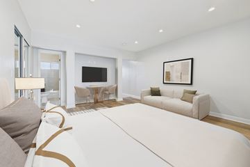 North Hollywood apartment for rent - A modern living room with a white sofa and a television.