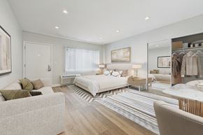 North Hollywood apartment for rent - A well-lit bedroom with a large bed and a wardrobe.