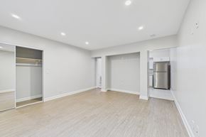 North Hollywood apartment for rent - A spacious room with a wooden floor and white walls.