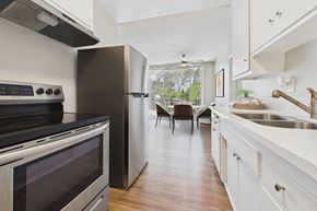 North Hollywood apartment for rent - A modern kitchen with a black stove top oven and a white refrigerator.