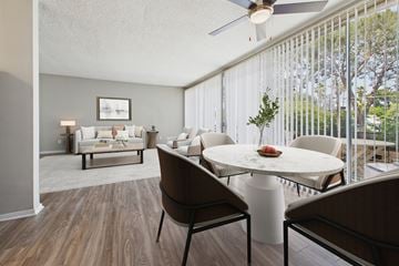 North Hollywood apartment for rent - A living room with a white couch and a dining table with chairs.