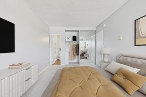 North Hollywood apartment for rent - A bedroom with a large bed and a wardrobe in the background.