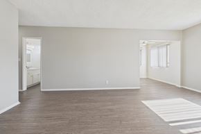 Garden Grove apartment for rent - A spacious room with wooden flooring and white walls.