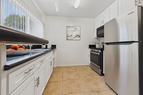 Sherman Oaks apartment for rent - A kitchen with white cabinets and a stainless steel refrigerator.
