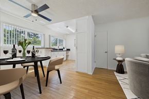 Sherman Oaks apartment for rent - A modern dining room with a table set for two and a ceiling fan.