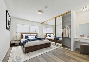 Sherman Oaks apartment for rent - A bedroom with a large bed and a mirrored closet door.