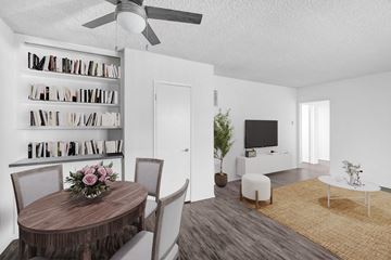 Los Angeles apartment for rent - A living room with a round wooden table and chairs, a television, a bookshelf, and a rug.