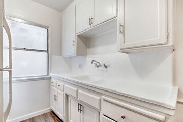 Los Angeles apartment for rent - A white kitchen with a refrigerator, cabinets, and a counter.