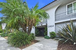 Van Nuys apartment for rent - A white building with the number 13464 on it.