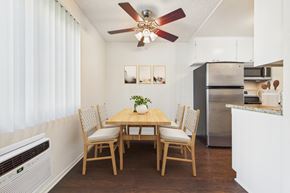 Van Nuys apartment for rent - A dining room with a wooden table and chairs.