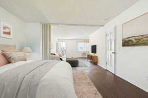 Van Nuys apartment for rent - A bedroom with a large bed and a green chair.
