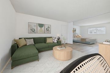 Van Nuys apartment for rent - A living room with a green couch and a wooden coffee table.