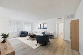 Sherman Oaks apartment for rent - A living room with a blue sofa and a wooden floor.