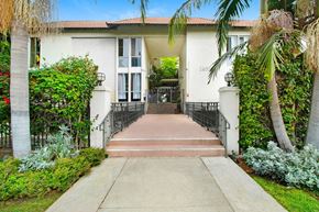Sherman Oaks apartment for rent - a house with palm trees and a sidewalk in front of it