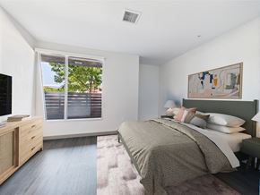 Los Angeles apartment for rent - A bedroom with a large bed and a painting on the wall.