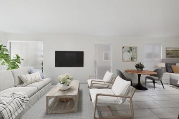 Marina Del Rey apartment for rent - A living room with a grey couch, a wooden coffee table, and a television mounted on the wall.
