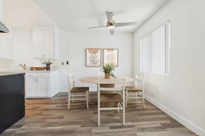 Van Nuys apartment for rent - A dining room with a table set for two and a ceiling fan.