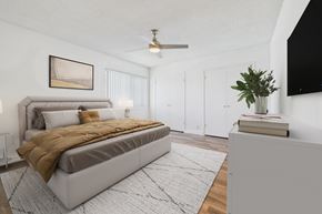 Van Nuys apartment for rent - A bedroom with a large bed and a ceiling fan.