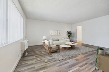 Van Nuys apartment for rent - A living room with a white couch and a wooden coffee table.