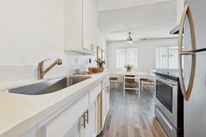 Van Nuys apartment for rent - A modern kitchen with a stainless steel oven and white cabinets.