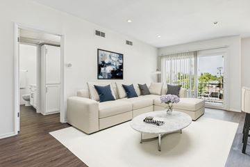 Van Nuys apartment for rent - A living room with a white couch and a coffee table.