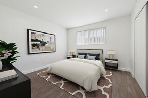 Van Nuys apartment for rent - A bedroom with a large bed and a painting on the wall.