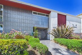 Van Nuys apartment for rent - A building with a red and white banner on the side.